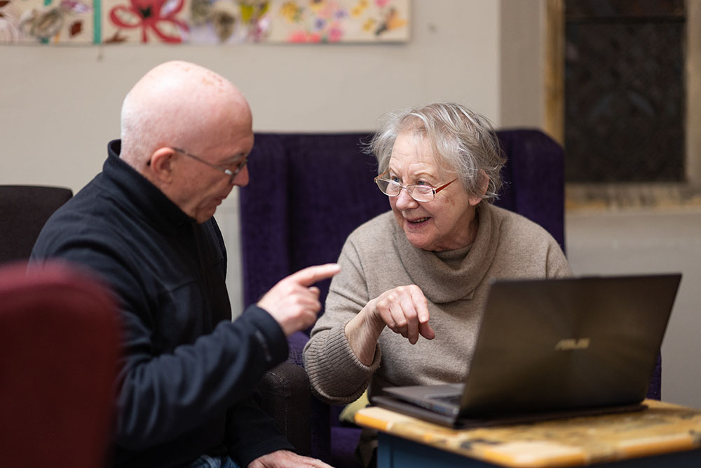 Senior man reading on a tablet in a comfortable chair